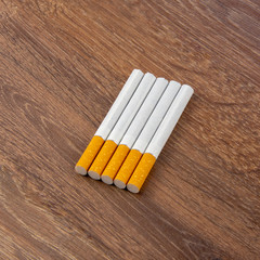 Close-up of filter cigarette on a wooden background