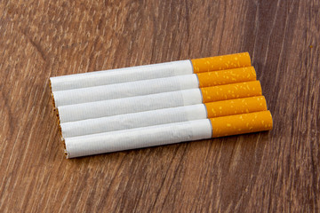 Close-up of filter cigarette on a wooden background