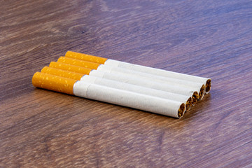 Close-up of filter cigarette on a wooden background