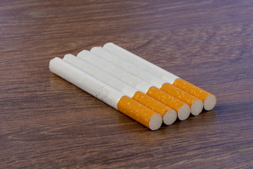 Close-up of filter cigarette on a wooden background