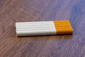 Close-up of filter cigarette on a wooden background