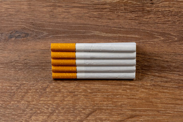 Close-up of filter cigarette on a wooden background