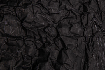 Fototapeta premium Black background. A crumpled texture. Close-up.
