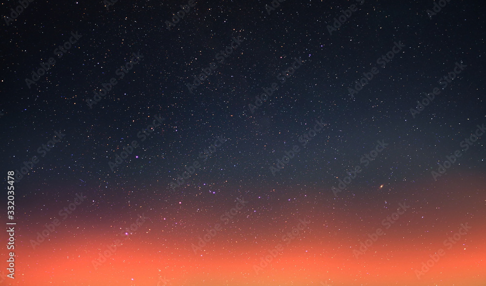 Wall mural starry sky and orange sunset summer night cloudy seascape nature background weather forecast