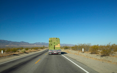 Hay truck drives back highways of Southern California