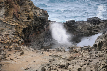 waves crashing on rocks blow hole 