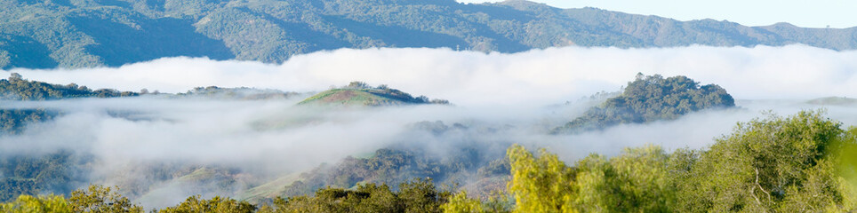 Panoramic landscape with clouds over green spring hills of Southern California, Ventura County, Oak View, CA