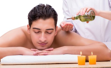 Fototapeta na wymiar Handsome man during spa massaging session