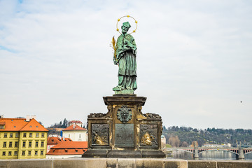 Fototapeta premium Prague, Czech republic - March 19, 2020. Statues of Charles Bridge without tourist during Covid-19 travel ban