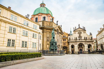 Prague, Czech republic - March 19, 2020. Square Krizovnicke namesti in front of entrance to Charles Bridge without tourists during Covid-19 travel ban