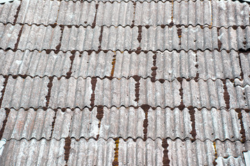 The surface of a tiled vintage roof is close