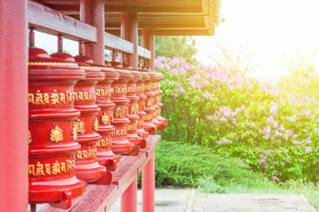Prayer wheels with written untranslatable mantras. The religious symbol of Buddhism.