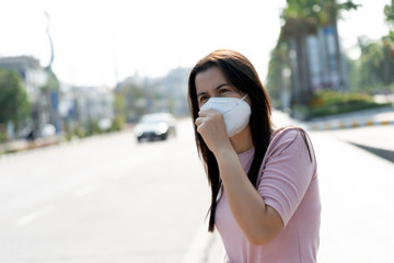 Close up of a woman in a suit wearing Protective face mask and cough, get ready for Coronavirus and...