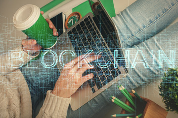 Double exposure of woman hands typing on computer and crypto market theme hologram drawing. Blockchain concept.