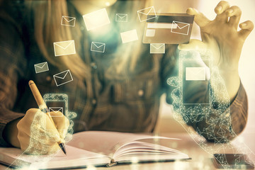 Multi exposure of woman on-line shopping holding a credit card and envelop drawing. e-commerce concept.