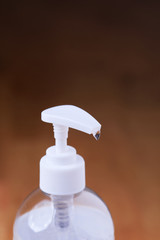 Fototapeta na wymiar Transparent hand sanitizer gel on a wooden background