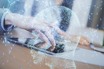 Double exposure of man and woman working together holding and using a mobile device and brain hologram drawing.