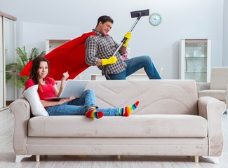Superhero husband helping his wife at home