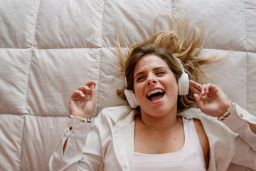 Fototapeta premium young girl with music on bed