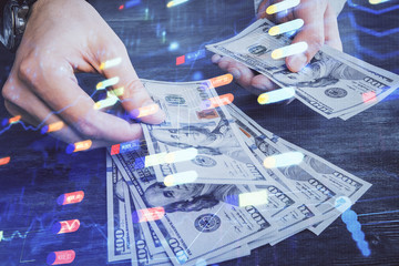 Multi exposure of technology drawing hologram and us dollars bills and man hands. Data concept