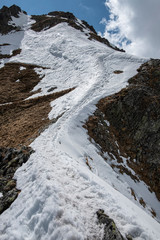 A narrow path in the snow along the mountain ridge 