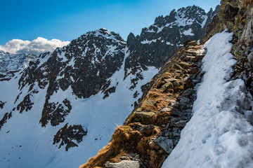 A  stony tourist path leading up the mountains along a steep slope