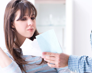 Young couple looking at family finance papers