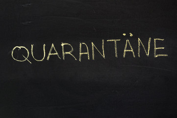 Fototapeta premium The word is in German quarantine. The text on the chalk Board. Yellow chalk