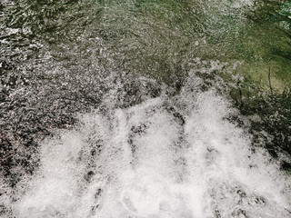 Top view of Pure fresh transparent mountain river water. Nature Flowing current shallow river. the clarity of creek at the foot of the mountain