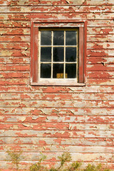 Distressed red barn side and window in Acadia National Park, Maine