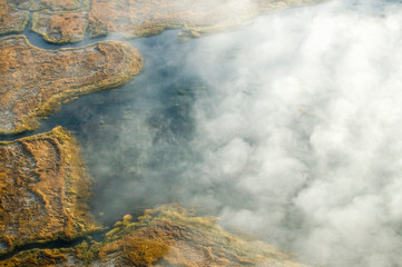 Aerial view of fog in autumn over islands and hills north of Portland Maine