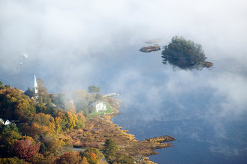 Aerial view of fog in autumn over islands and hills north of Portland Maine