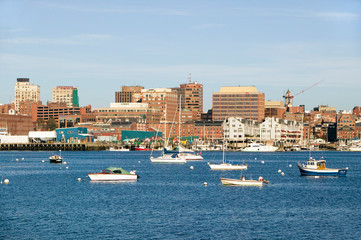 Fototapeta na wymiar View of Portland Harbor boats with south Portland skyline, Portland, Maine