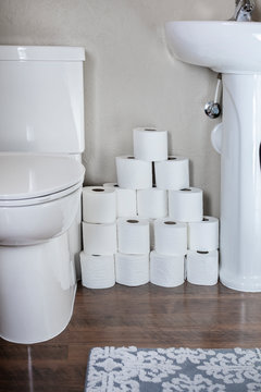 Large Stack Of Toilet Paper Rolls In A Residential Bathroom. Home Preparedness For Emergency Situations. Stocking Up On The Essentials.