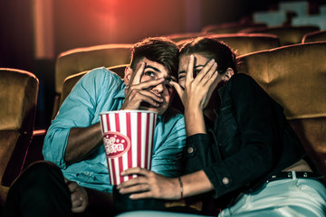 A couple lover watching movie in cinema theater.
