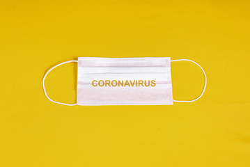 Surgical mask over minimalist orange background