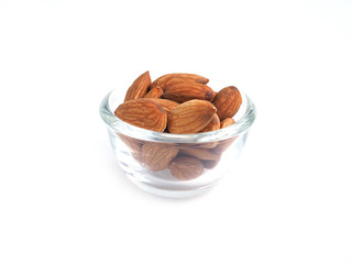 Almonds seeds in glass bowl isolated on a white backgroud..