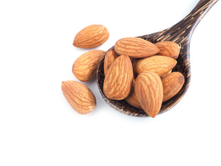 Almond seeds in wooden spoon isolated on a white backgroud. Healthy food...