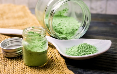 Mitragyna speciosa or Kratom powder in ceramic spoon and glass jars