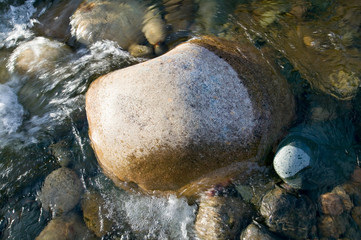 Rock in autumn stream at Crawford Notch State Park in White Mountains of New Hampshire, New England