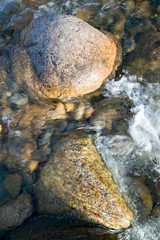 Rock in autumn stream at Crawford Notch State Park in White Mountains of New Hampshire, New England