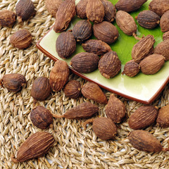 heap of black cardamom whole seeds 