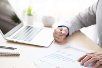 Businessman boss is inspecting the business reports graphs to audit the financial reports. Analyzing the revenue and auditing the budget concept.