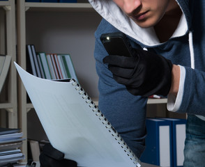 Young man in industrial espionage concept