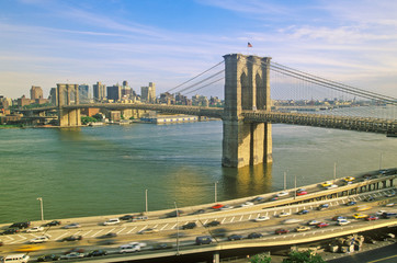 Long view of Brooklyn Bridge over East River to Brooklyn with FDR River, NY