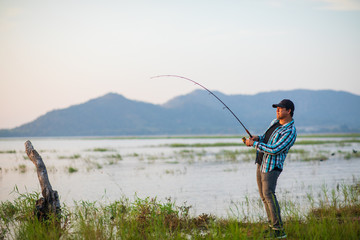 Office man self quarantine in with the nature by fishing in the lake. Quarantine concept