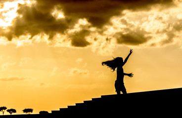 silhouette of a girl jumping on the beach
