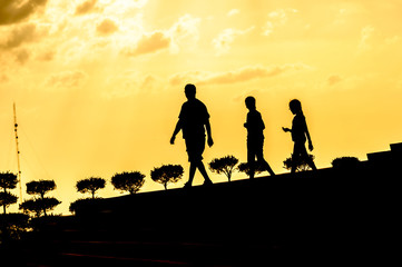 Fototapeta na wymiar silhouette of family at sunset