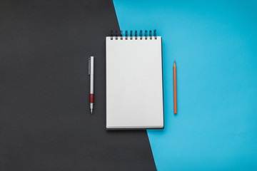Open notebook with a pen and a pencil