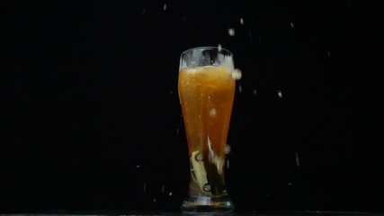 Car falls into a glass with alcohol on a black background, concept of road safety, alcohol abuse, driving while intoxicated, slow motion - Powered by Adobe